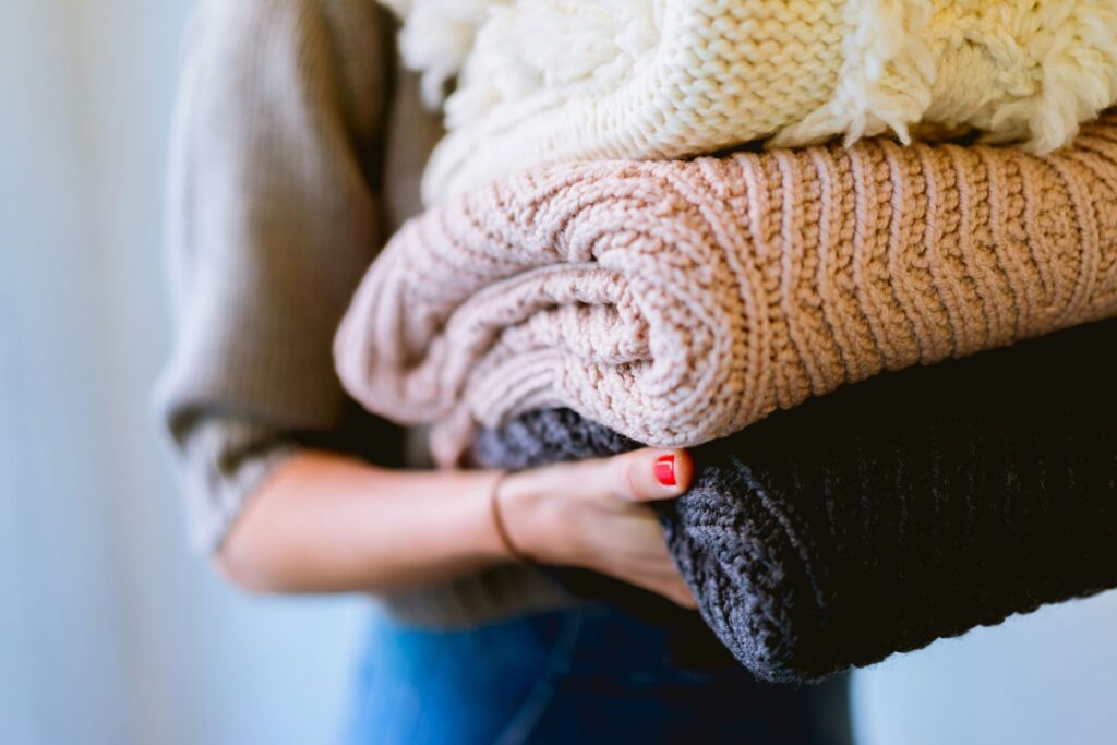 Woman carrying folded laundry